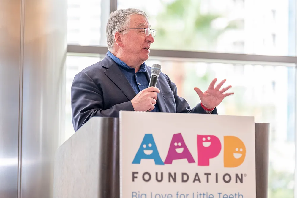 Dr. Charles Czerepak speaking at the AAPD Foundation podium.