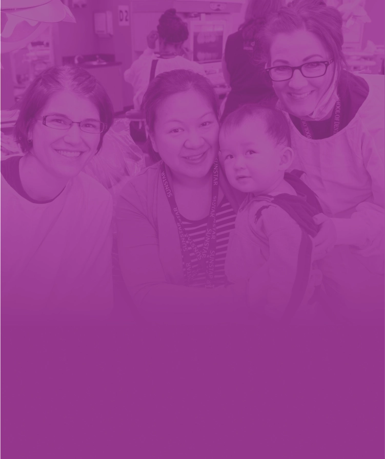 Two providers alongside of a mother and son patient.