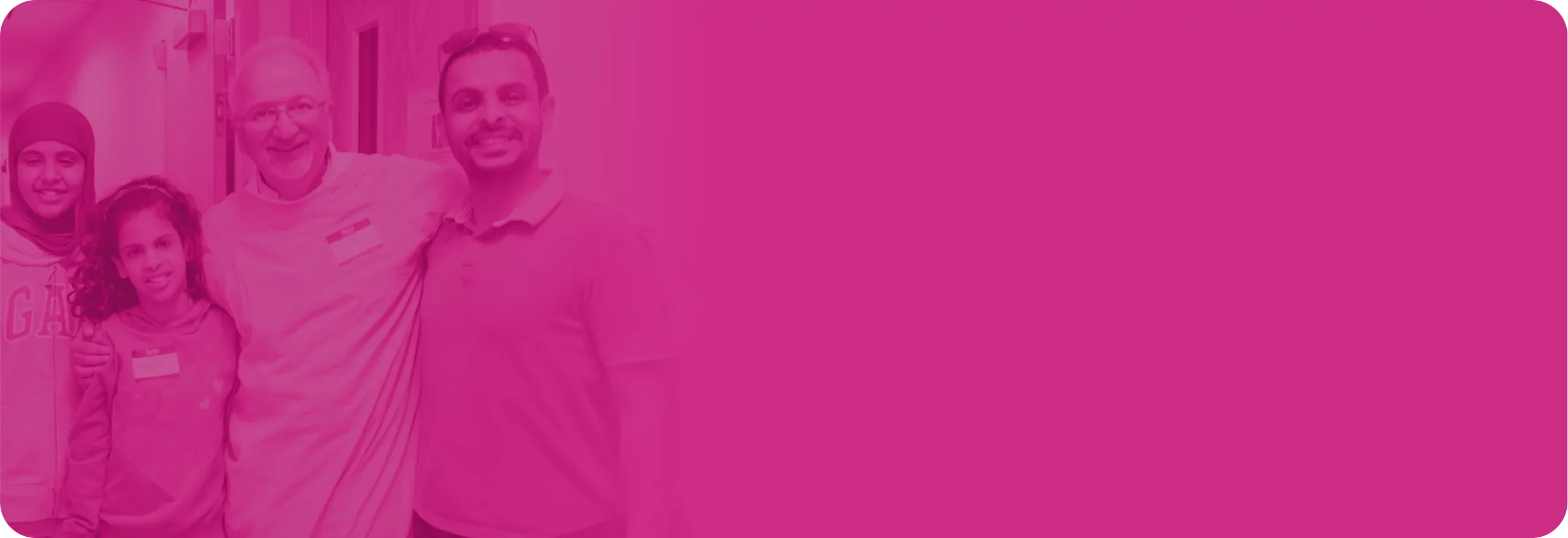 A provider and family arm-in-arm and smiling in a dentist office.