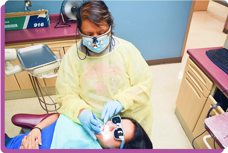 Pediatric dentist caring for a child at CommuniCare - access expanded by an AAPD Foundation Access to Care Grant.