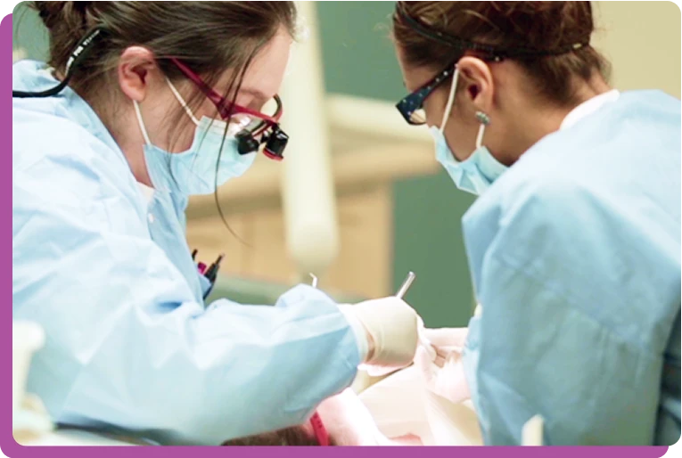 CommuniCare dental team delivering compassionate pediatric care to a refugee child.